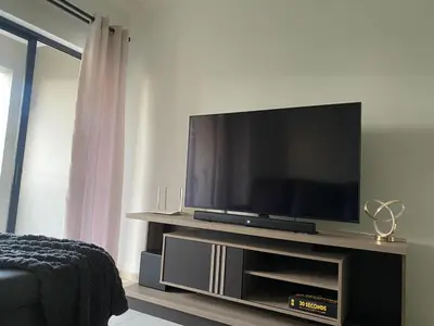 a flat screen tv sitting on a entertainment center at Where every guest feels special in Midrand