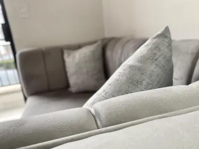 a couch in a living room with pillows on it at A small haven - The blyde crystal lagoon in Pretoria