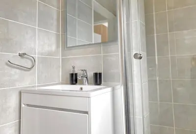 a bathroom with a white sink and a shower at A small haven - The blyde crystal lagoon in Pretoria