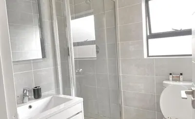 a bathroom with a shower and a sink and a toilet at A small haven - The blyde crystal lagoon in Pretoria