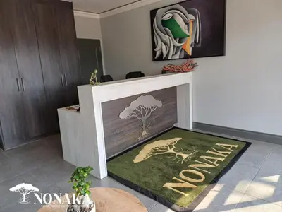 a living room with a fireplace with a tree rug at Nonaka in Louis Trichardt