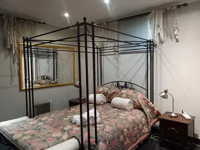 a bedroom with a bed with a wrought iron frame at AAA Accommodation in Pretoria