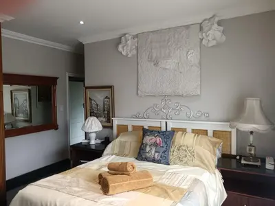 a bedroom with a bed with a towel on it at AAA Accommodation in Pretoria