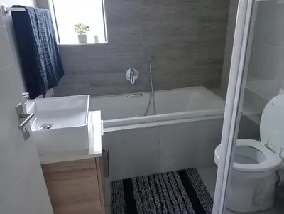 a bathroom with a tub and a toilet and a sink at Irene Moo Stay in Pretoria