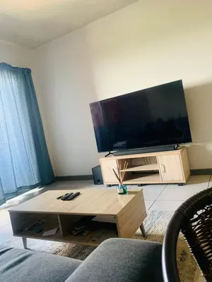 a living room with a large flat screen tv at Luxury Park Stays in Midrand