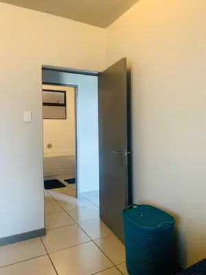 a hallway with a door and a trash can at Luxury Park Stays in Midrand