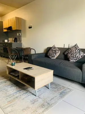 a living room with a couch and a coffee table at Luxury Park Stays in Midrand