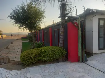 a building with red paint on the side of a street at MamSwazi & Bitana Resorts n Restaurants in Pretoria