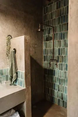 a bathroom with a sink and a shower with blue tiles at Chawal Stays Ribbok in Marloth Park