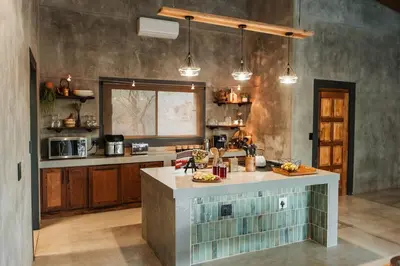 a kitchen with a island in the middle of a room at Chawal Stays Ribbok in Marloth Park