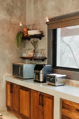 a kitchen with two microwaves and a microwave on a counter at Chawal Stays Ribbok in Marloth Park