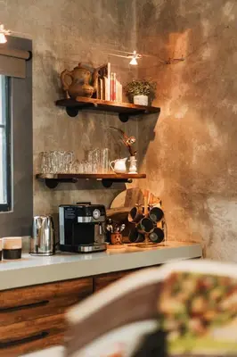 a kitchen with a counter with shelves and a microwave at Chawal Stays Ribbok in Marloth Park