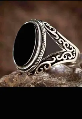 a silver ring with a black stone on a rock at The Best African healer love spell sangoma in mankweng in Polokwane