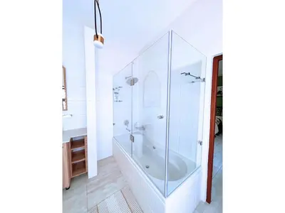 a white bathroom with a tub and a sink at Mushavi Manor in Sybrandskraal
