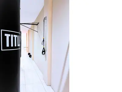 a hallway with white walls and a black door at Mushavi Manor in Sybrandskraal