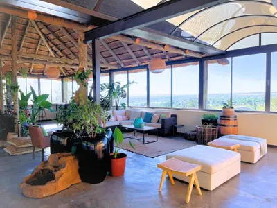 a large living room with a lot of windows at Mushavi Manor in Sybrandskraal