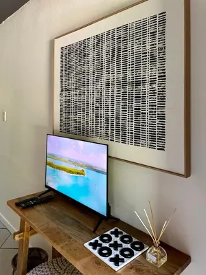 a computer monitor sitting on a wooden table at Pass-through Apartments in Pretoria