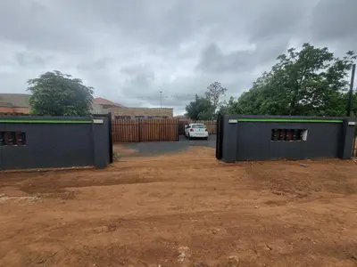 a garage with a car parked in a driveway at Eazistay Motel - Letlhabile in Brits