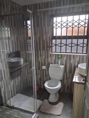 a bathroom with a toilet and a sink at Eazistay Motel - Letlhabile in Brits