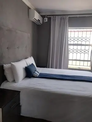 a large bed in a room with a window at Matswabolle Guest Lodge in Gowe