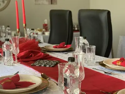 a table with plates and glasses and red napkins at Catwalk Lodge in Pretoria