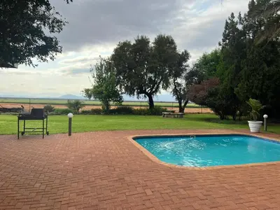 a small swimming pool sitting on a brick patio at Riecor Guest Farm in Thabazimbi
