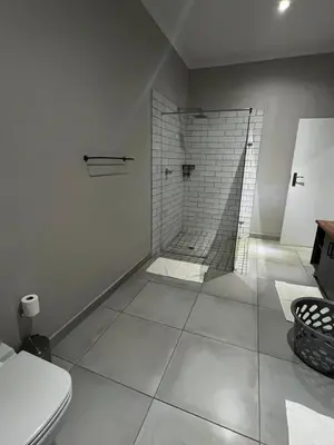 a bathroom with a shower and a toilet at Riecor Guest Farm in Thabazimbi