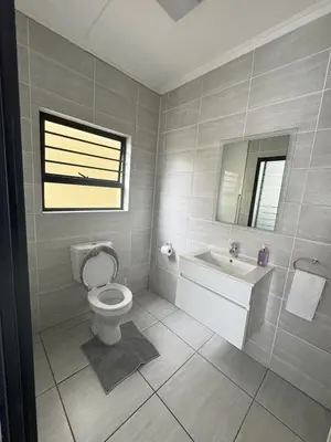 a bathroom with a toilet and a sink at Comfy 2-Bedroom at Kikuyu Estate in Johannesburg