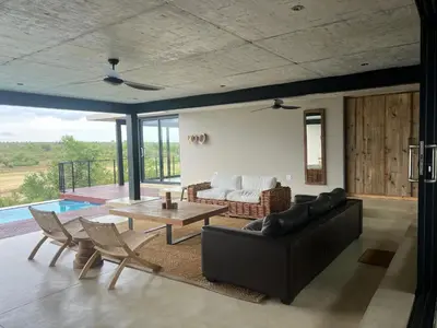 a living room with a couch and a table at Horizons River Lodge Mjejane in Hectorspruit