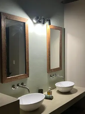 a bathroom with two sinks and two mirrors at Horizons River Lodge Mjejane in Hectorspruit