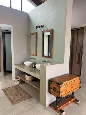a bathroom with a sink and two mirrors on the wall at Horizons River Lodge Mjejane in Hectorspruit