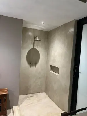 a bathroom with a shower with a round mirror on the wall at Horizons River Lodge Mjejane in Hectorspruit