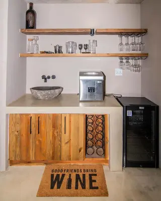 a kitchen with a counter with a wine sign on it at Horizons River Lodge Mjejane in Hectorspruit