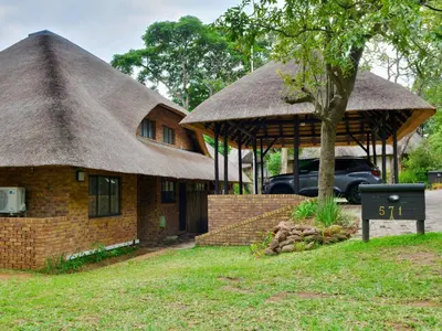 a house with a thatched roof and a sign in front of it at Kruger Park Lodges - Pangane M Properties Unit 538, 571A, 571B in Hazyview