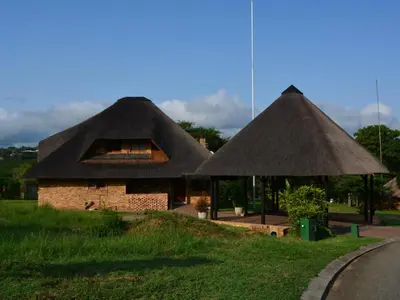two huts with thatched roofs on the side of a road at Kruger Park Lodges - Pangane M Properties Unit 538, 571A, 571B in Hazyview