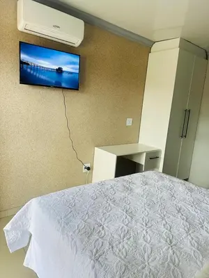 a bedroom with a bed and a tv on the wall at Maduwa Guest House in Pretoria