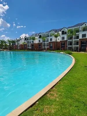 a large swimming pool in front of apartment buildings at Kayalako at theBlyde 1 in Pretoria
