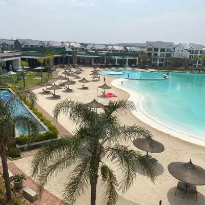a resort with a beach with umbrellas and a pool at Kayalako at theBlyde 1 in Pretoria