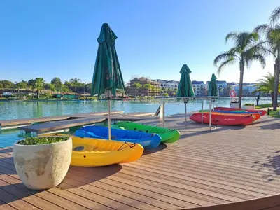 a group of kayaks and umbrellas on a wooden boardwalk at Kayalako at theBlyde 1 in Pretoria