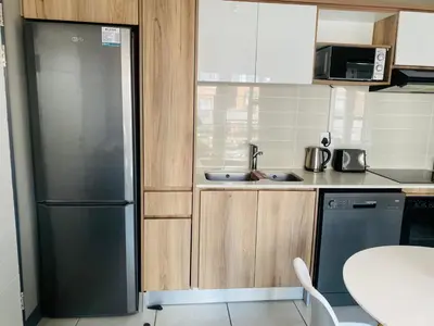 a kitchen with a black refrigerator and a sink at Kayalako at theBlyde 1 in Pretoria