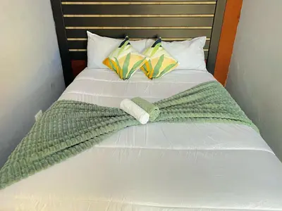 a bed with two blankets and pillows on it at MD Guesthouse Debruin park in Ermelo