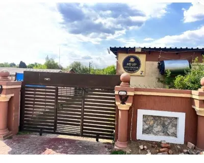 a fence with a sign on the side of a building at MD Guesthouse Debruin park in Ermelo