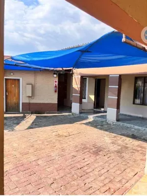 a building with a blue umbrella on top of it at MD Guesthouse Debruin park in Ermelo