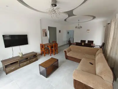 a living room with a couch and a flat screen tv at Masingita Guest House in Graskop