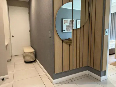 a bathroom with a mirror and a stool at Modern holiday home in Pretoria