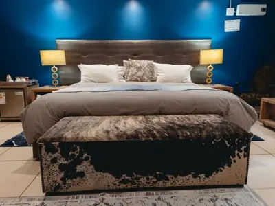 a bedroom with a large bed with a blue wall at Highveld Splendour Boutique Bed and Breakfast in Ermelo