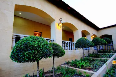 a building with a bunch of trees in front of it at La Villa Spa in Nelspruit