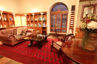 a living room with a couch and a table at La Villa Spa in Nelspruit