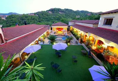 an overhead view of a courtyard with tables and umbrellas at La Villa Spa in Nelspruit