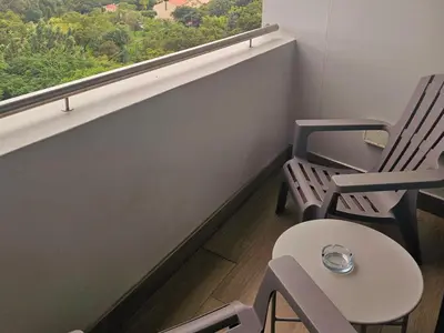 a room with two chairs and a window at 514 at The Regency in Pretoria